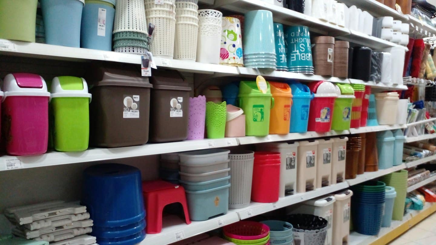 Scaffali di un negozio di alimentari pieni di articoli colorati per la casa in plastica.